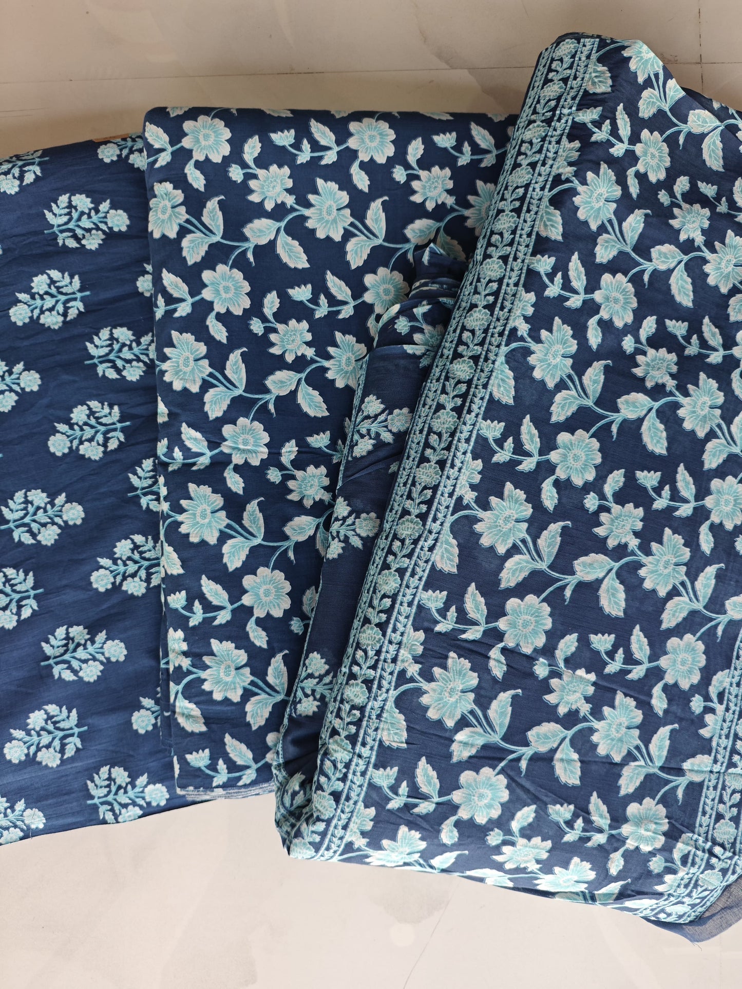 navy blue base with soft aqua floral motifs